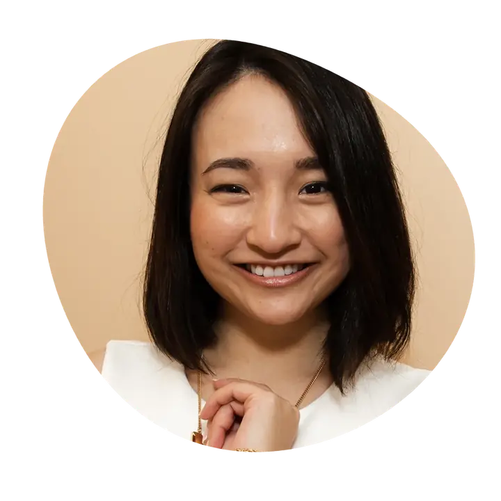 Joyce Akiko smiling, in a white top