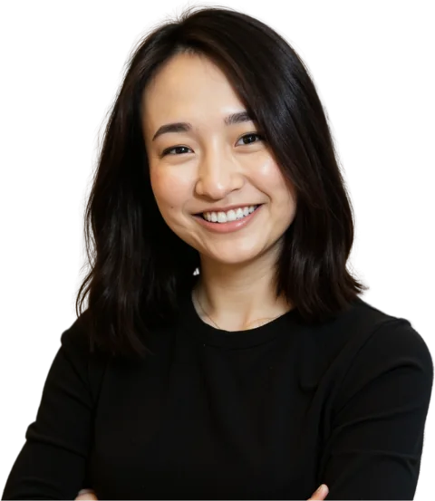 Joyce Akiko smiling with her arms crossed, in a black top